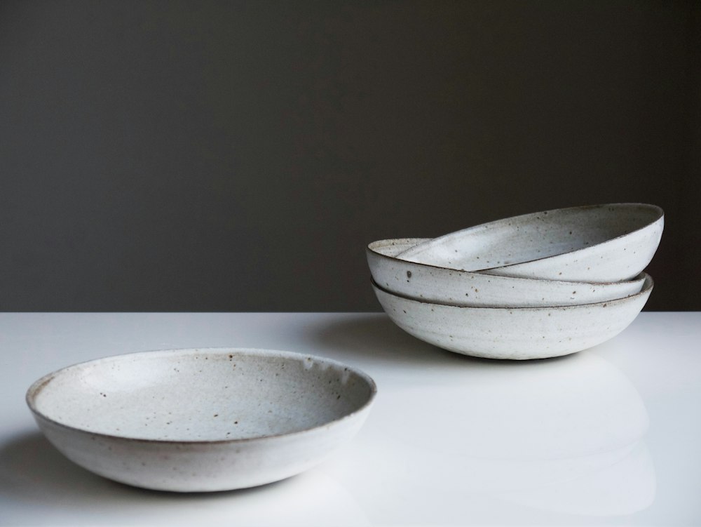 Four white ceramic bowls