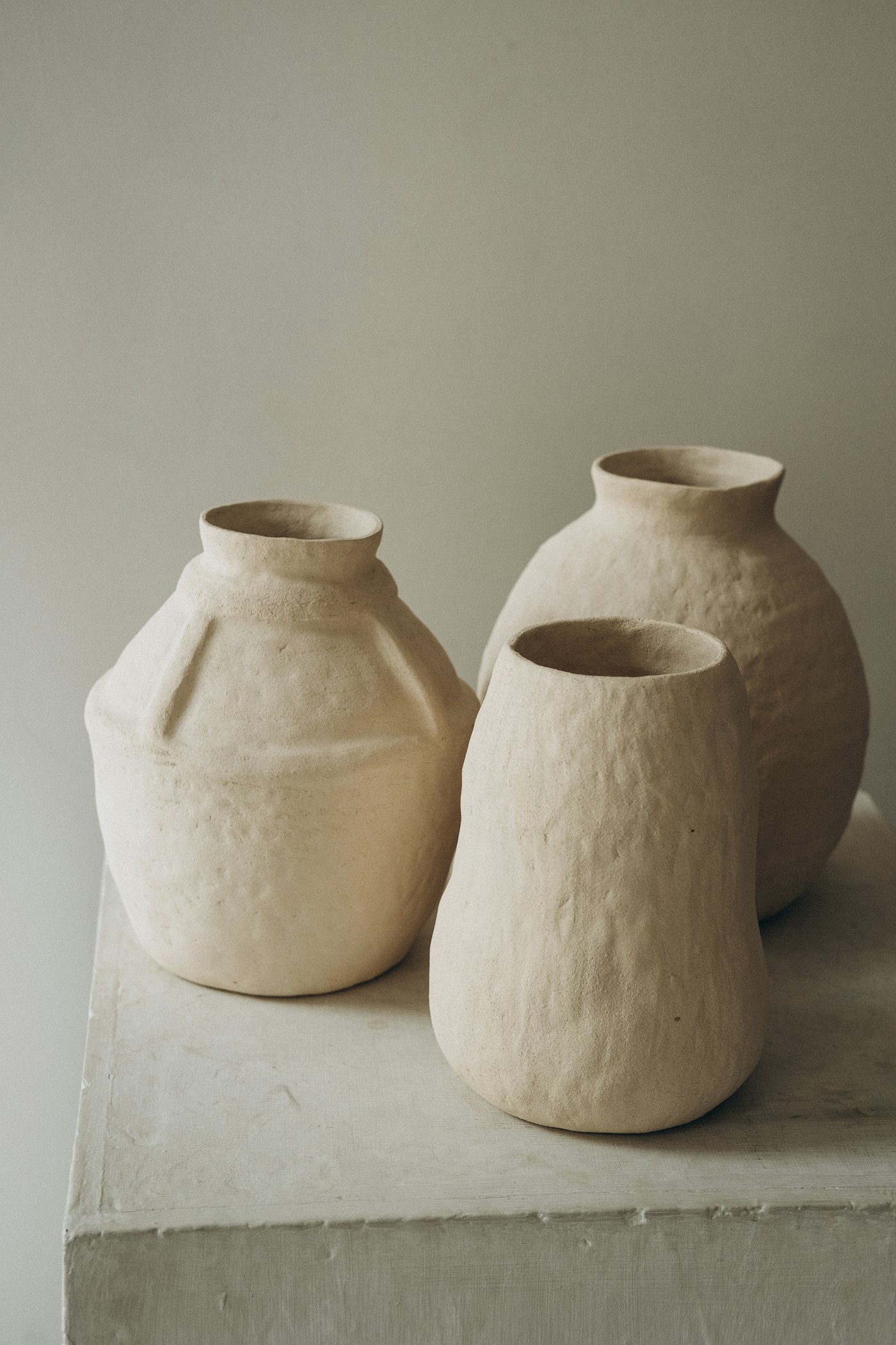 Three white ceramic jars