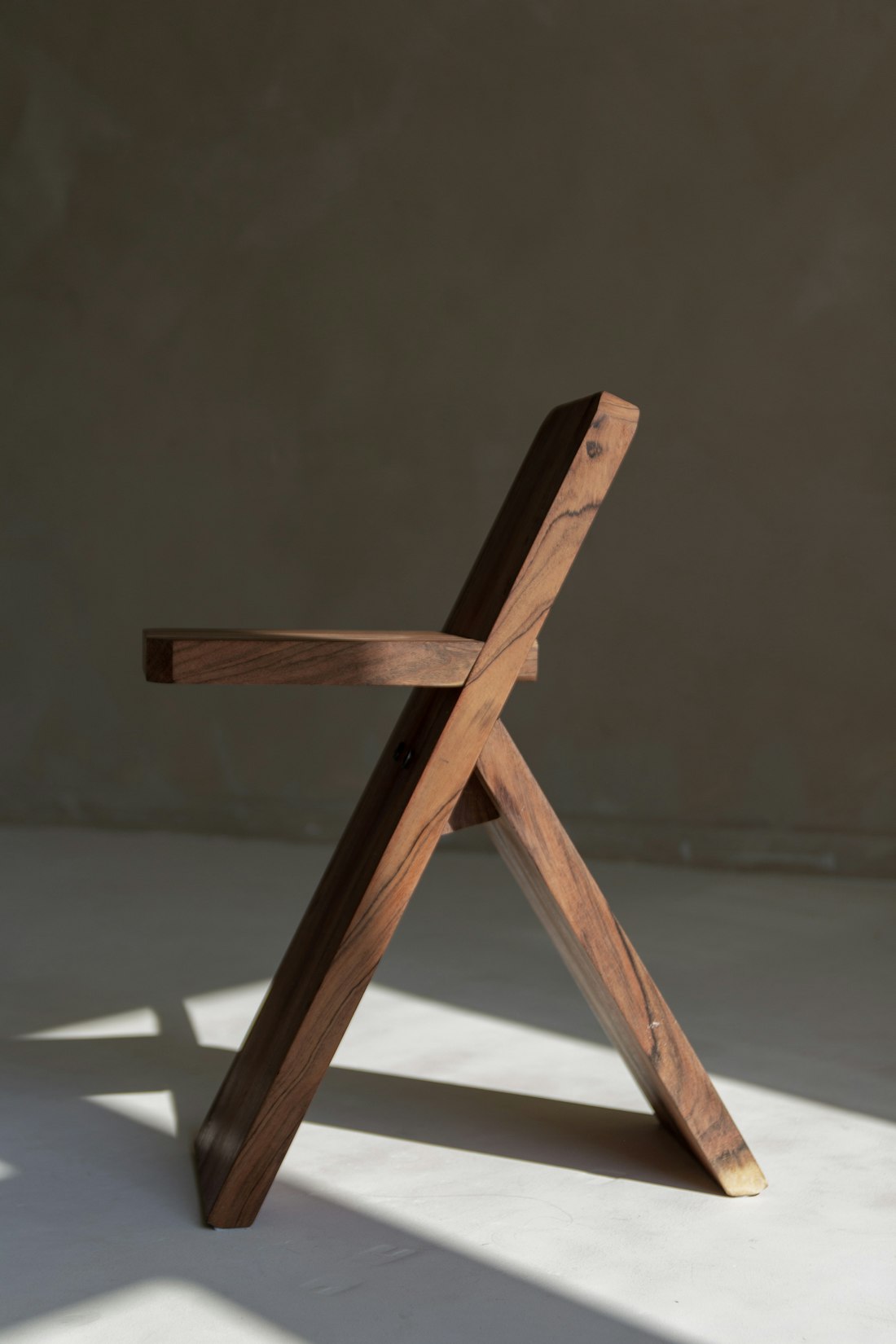 A sculptural oak chair in raking light