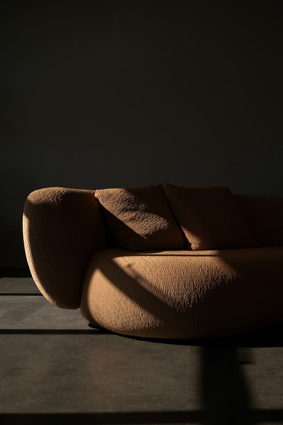 Textured sofa in dramatic afternoon sunlight